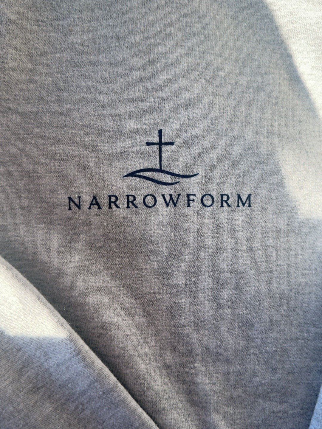 NARROWFORM cross and narrow path logo on grey fabric